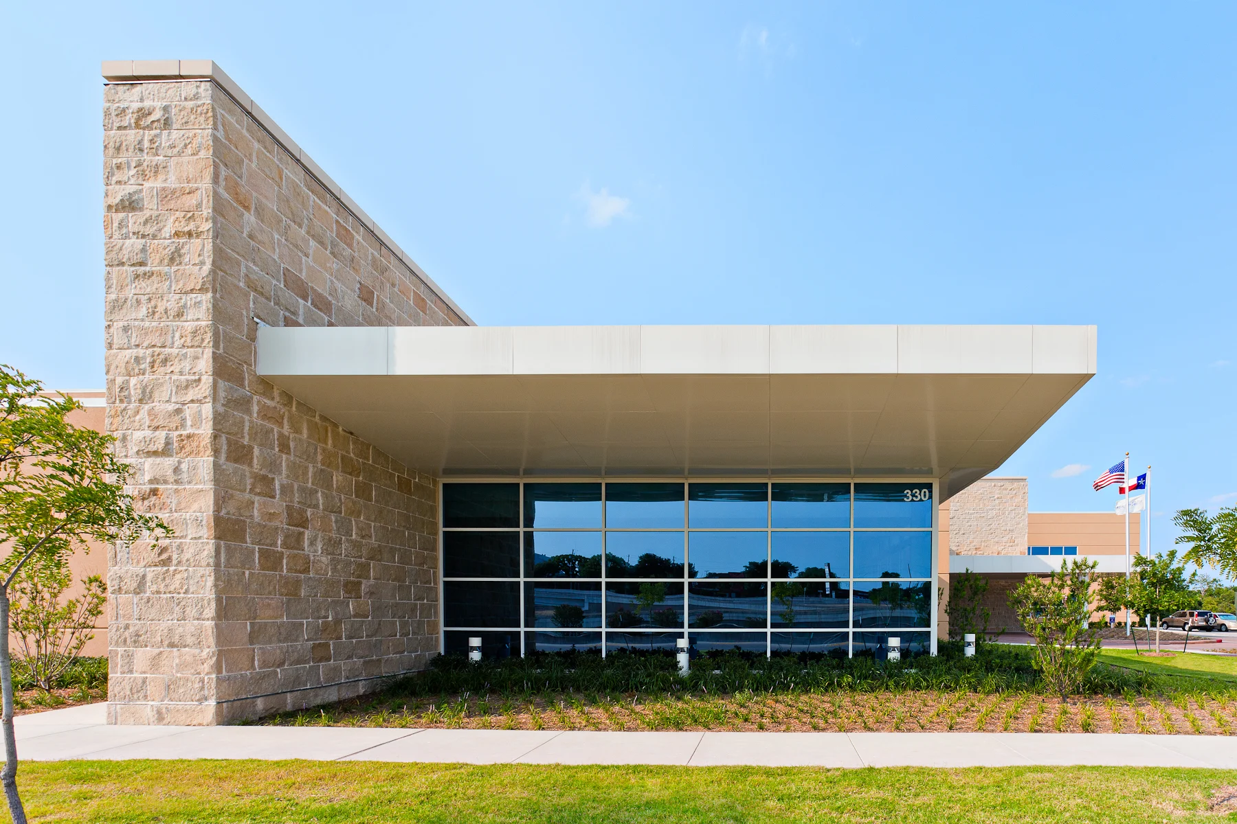 stone awning with floor to ceiling windows
