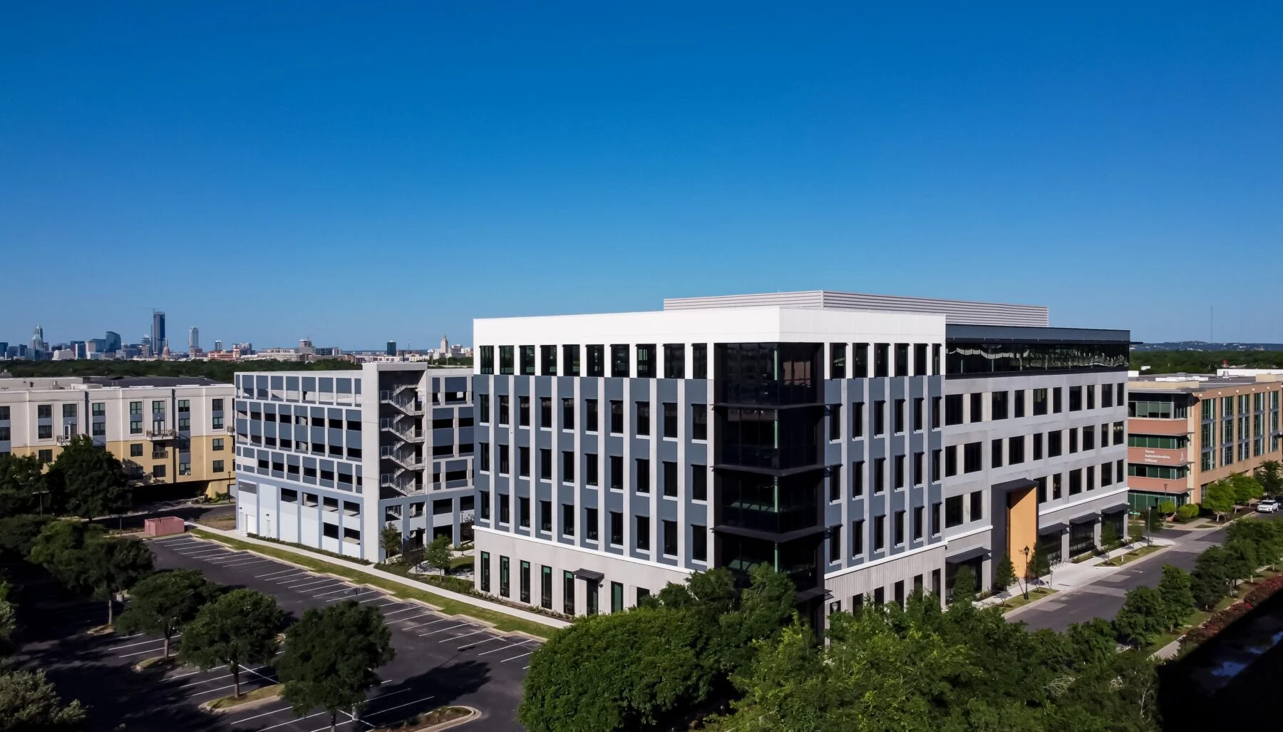 five story tilt-wall medical office building with connecting skywalk bridge and parking garage