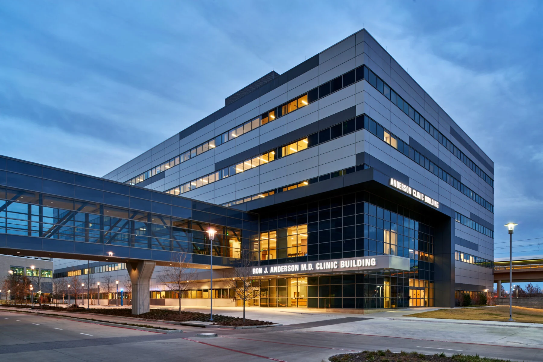 exterior medical building at night with skybridge