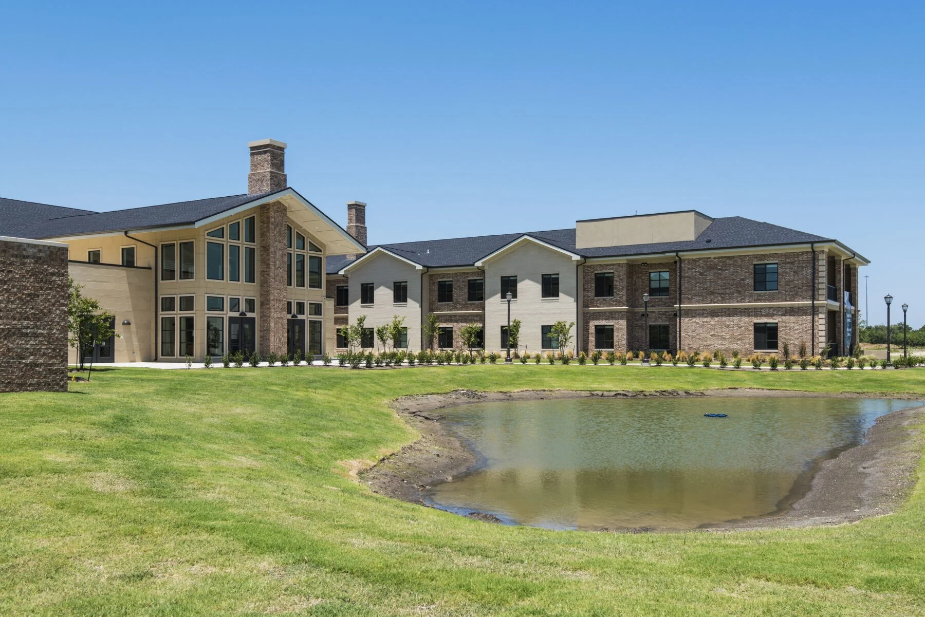 exterior two story retirement home with pond
