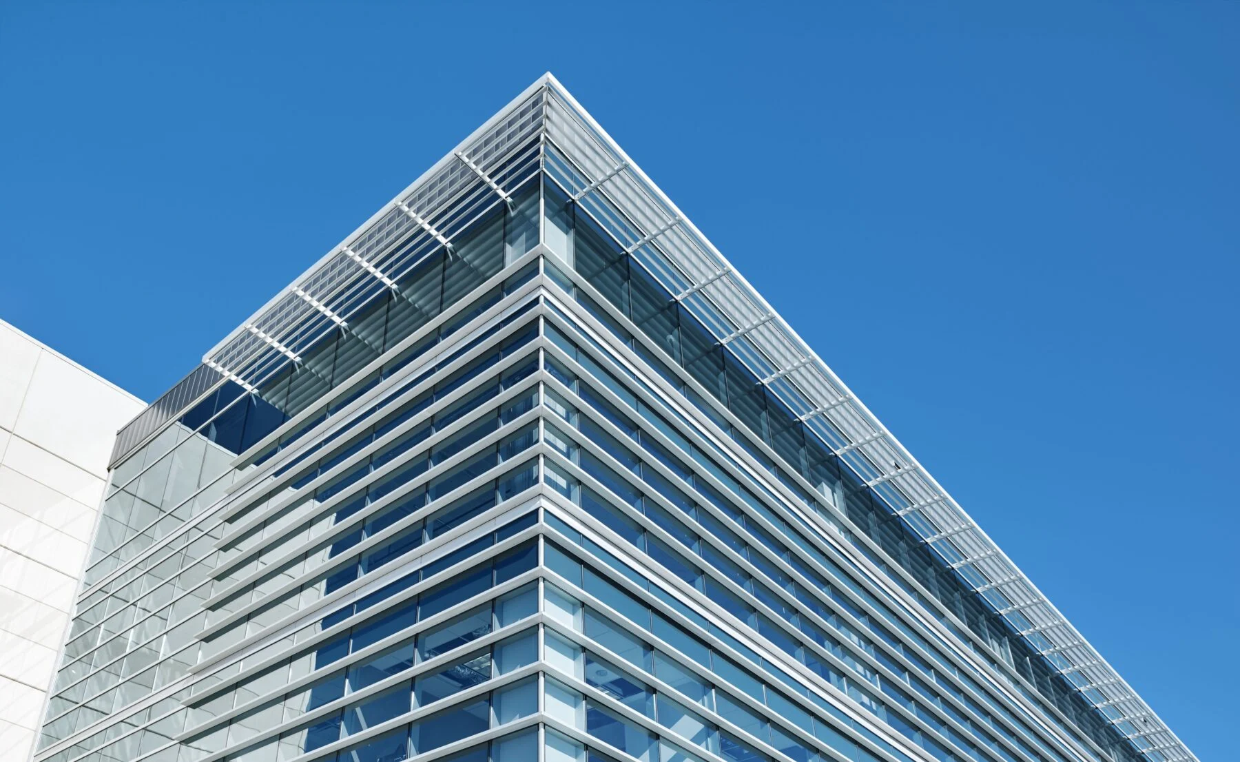 Curved glass façade of the Lamar Central office building in Austin.
