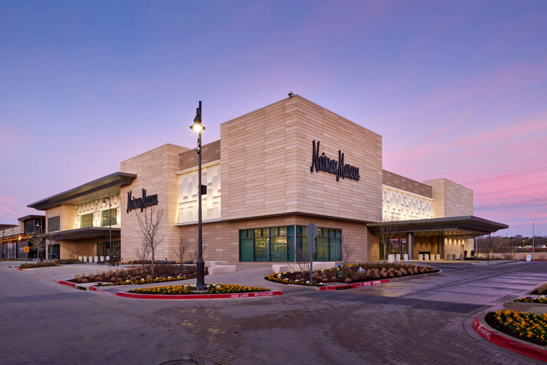Exterior facade of Neiman-Marcus store front at sunset.