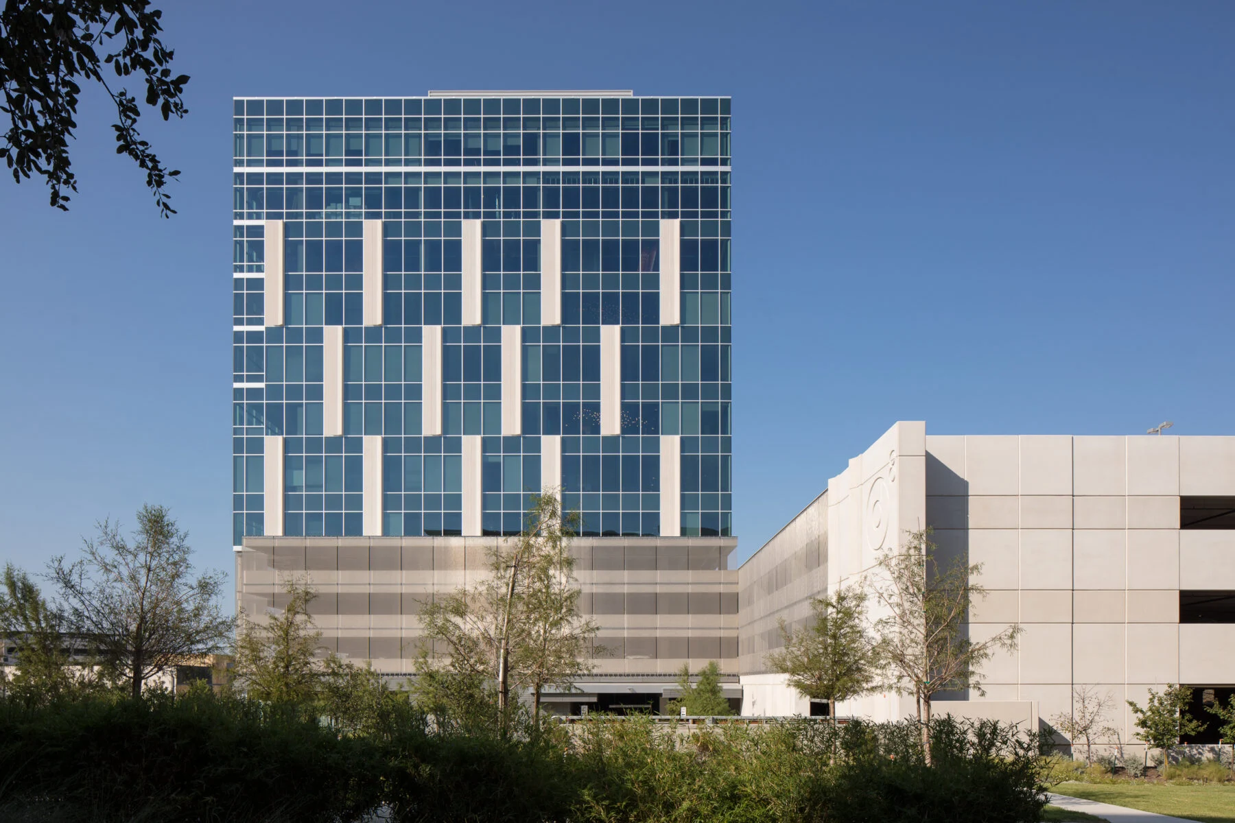 office building with glass and parking garage