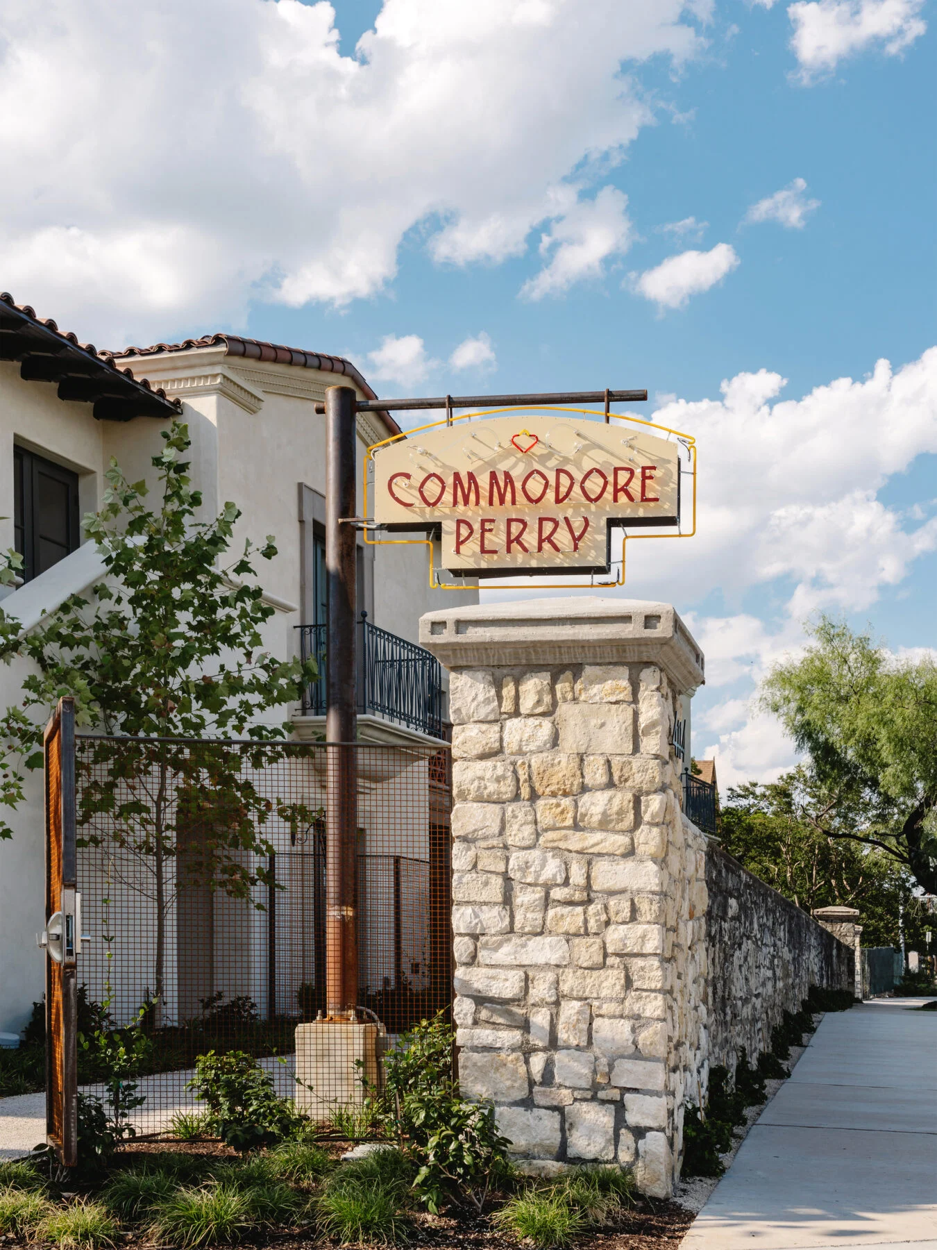 Entrance to Commodore Perry Estate with hanging sign and stone faced