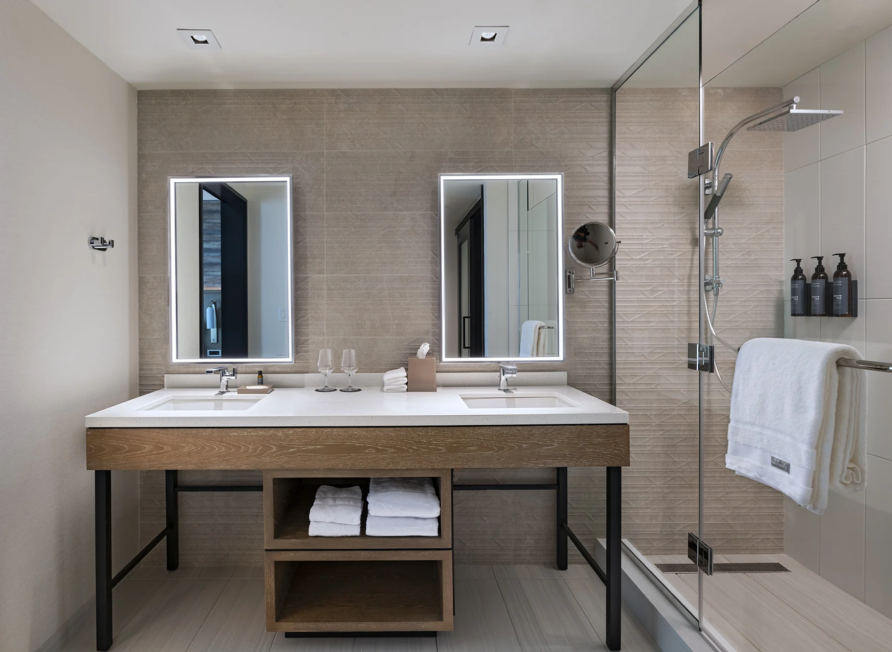 Double vanity bathroom with shower at hotel.