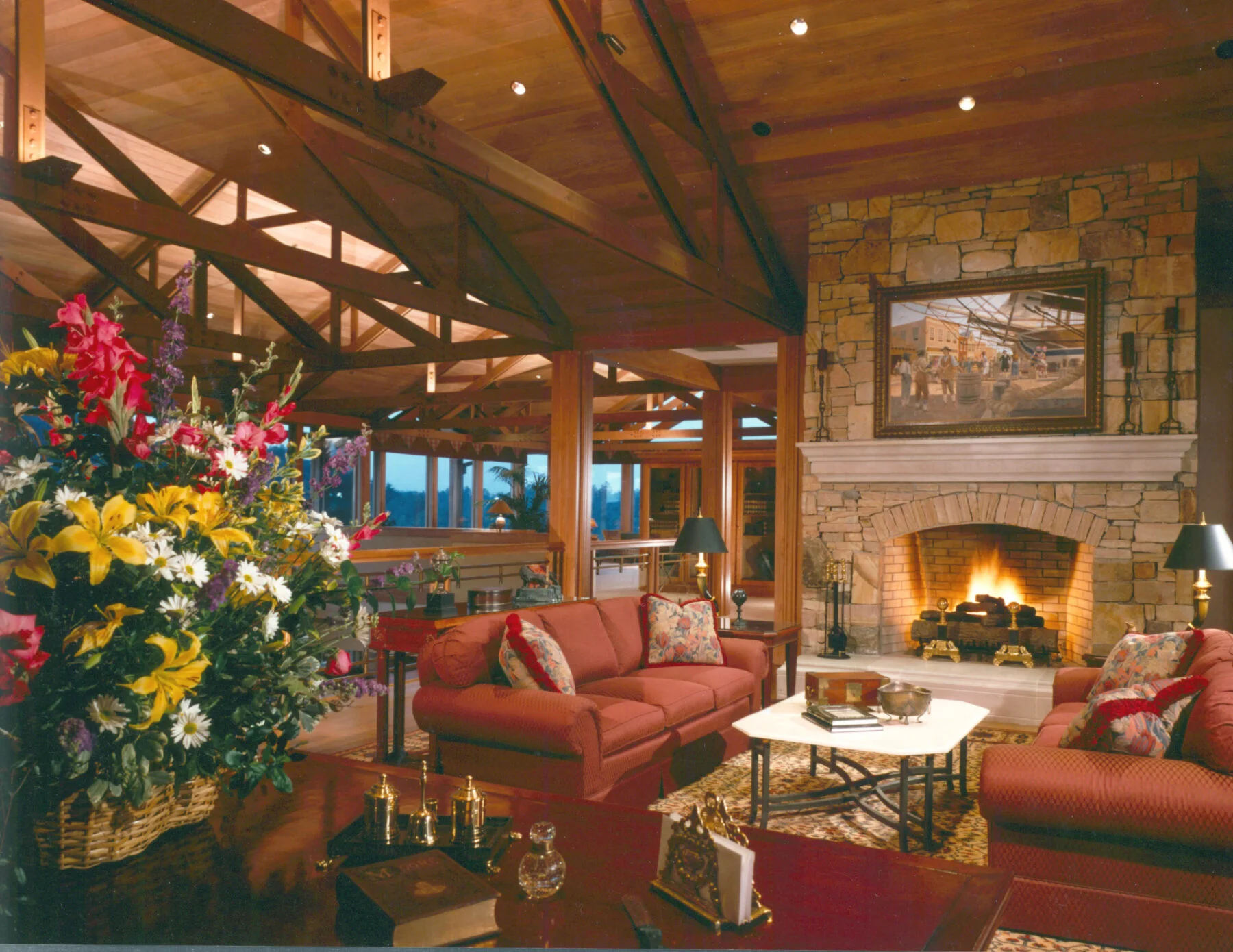 Fireplace with stone work and cozy seating in open living room
