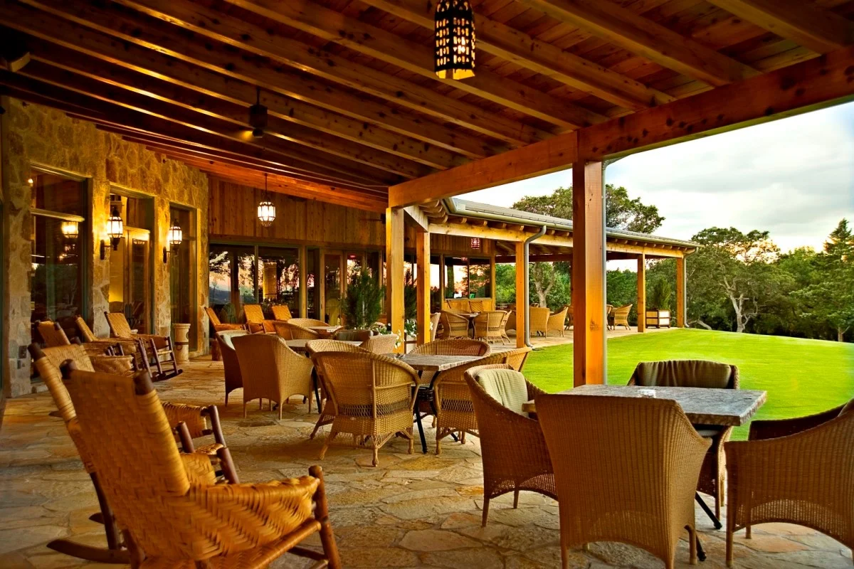 Patio overlooking golf course with a variety of furniture