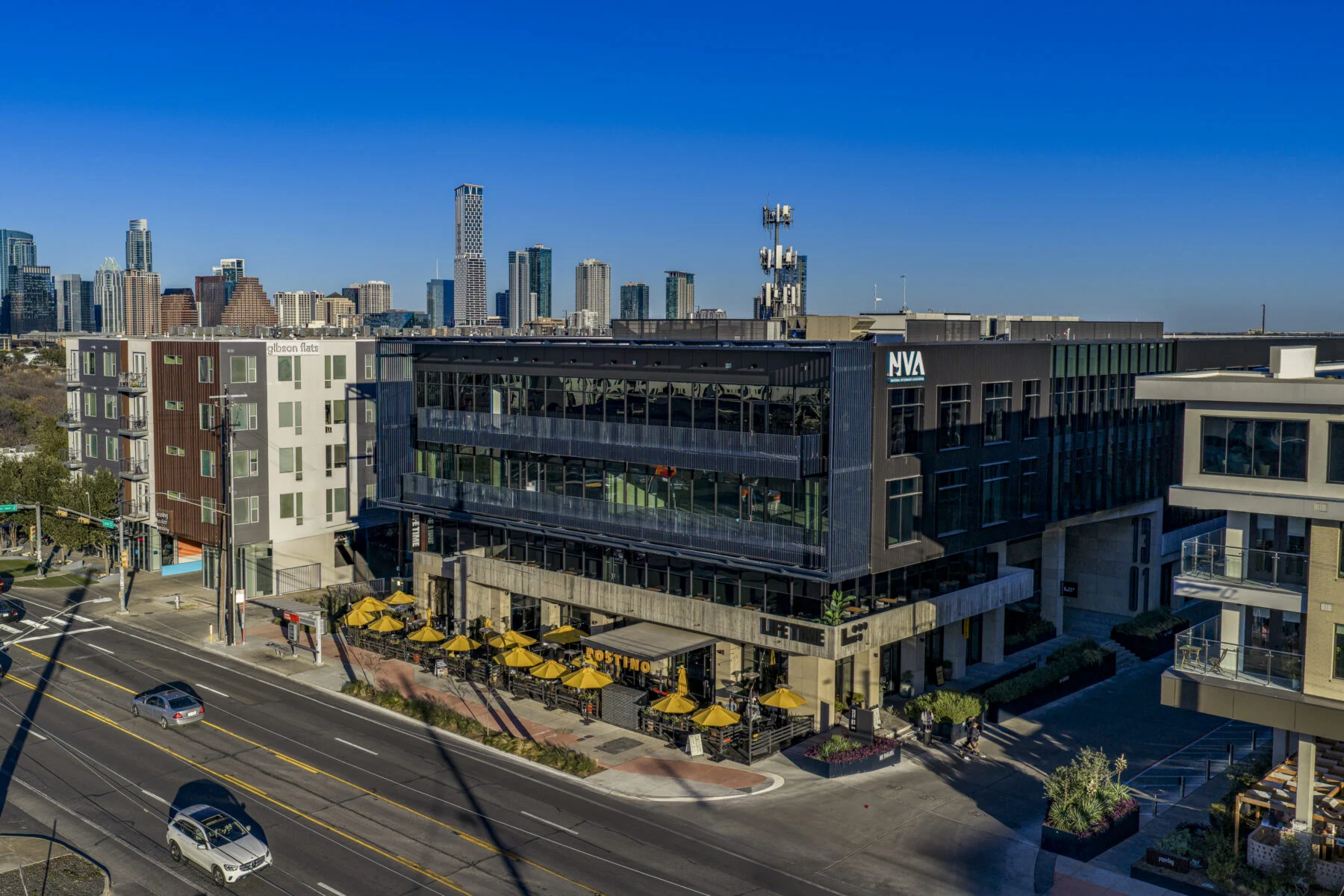 four story building with austin skyline in the background