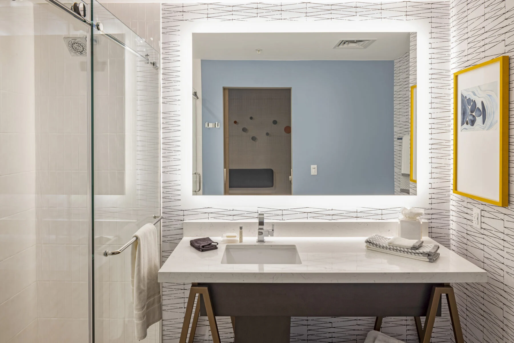 Large bathroom with shower and bright lighting