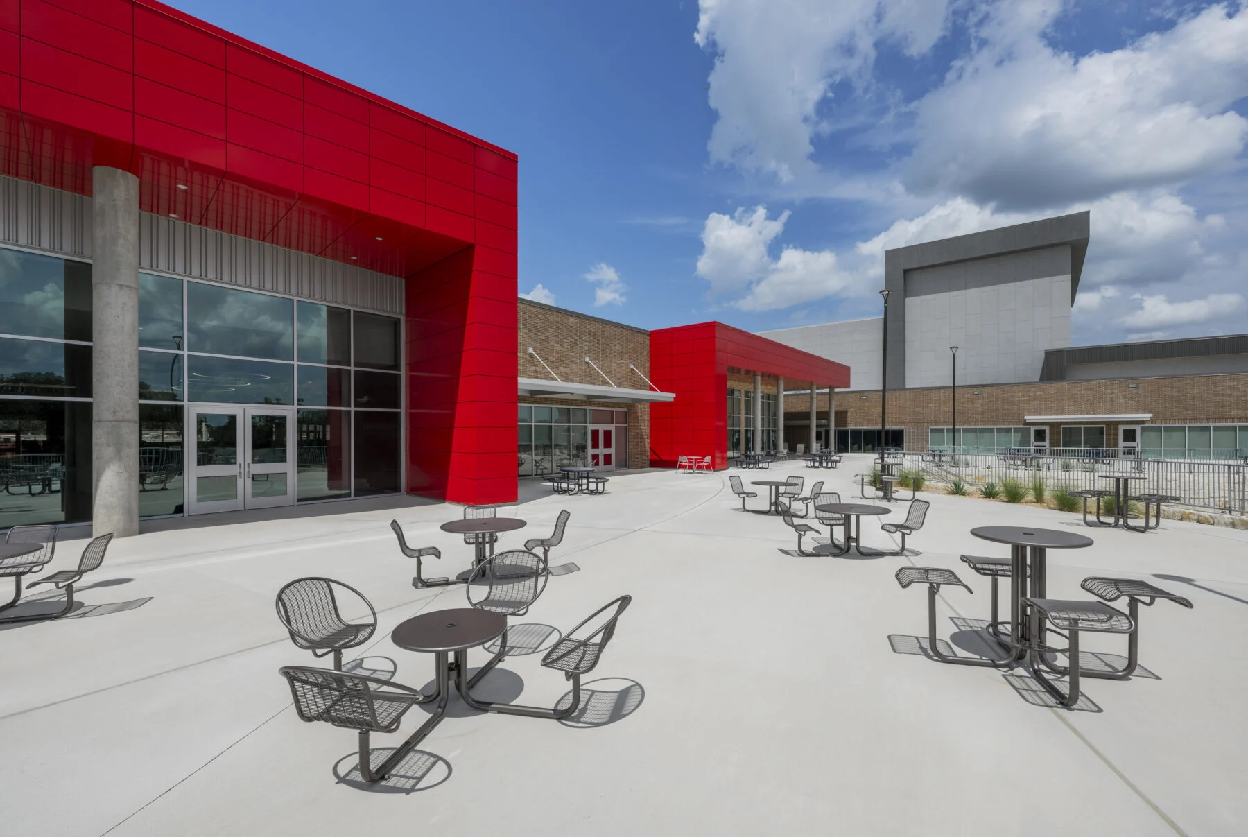 outdoor gathering and eating space with custom red arches