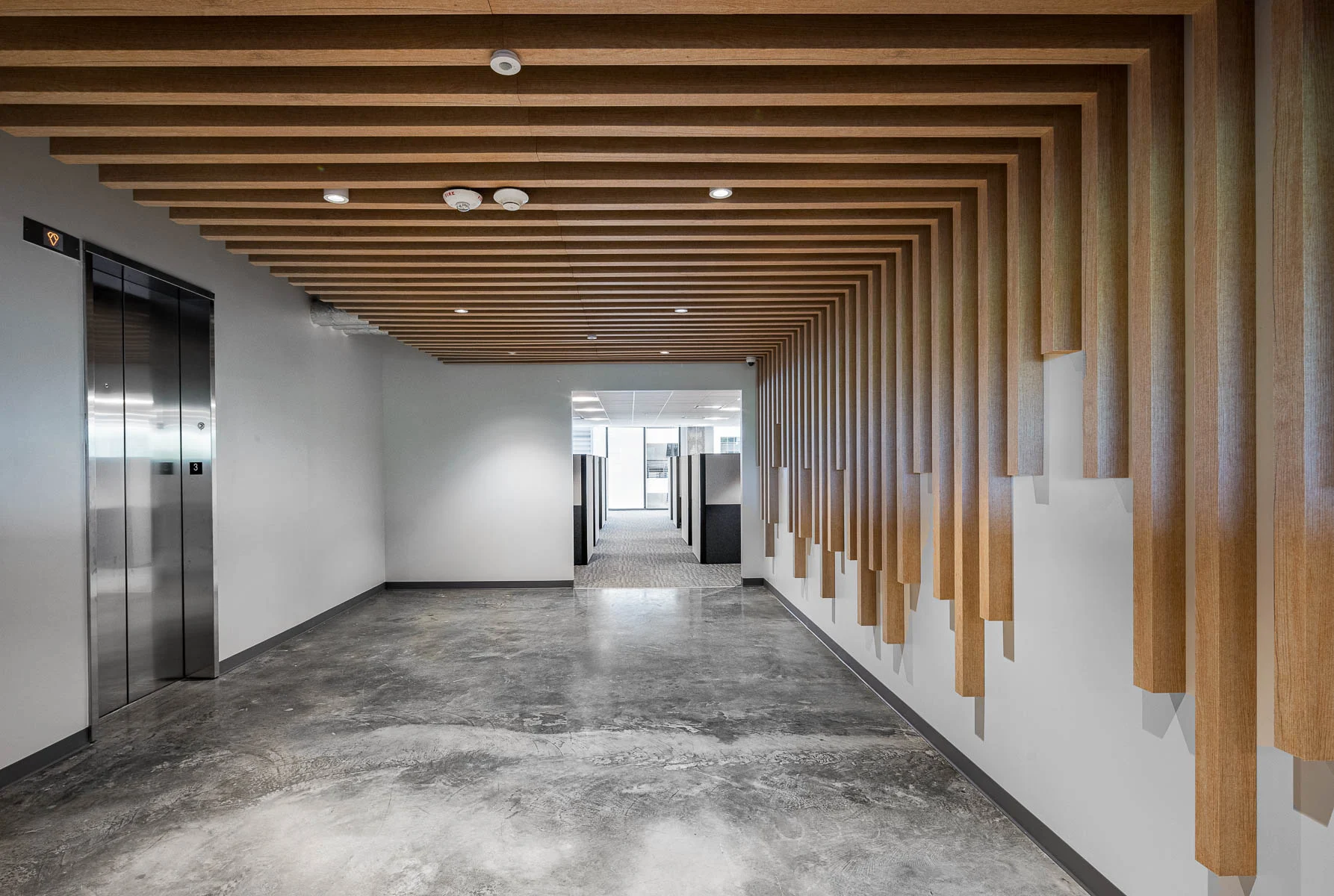 lobby of advanced manufacturing space with custom wooden millwork on walls and ceilings