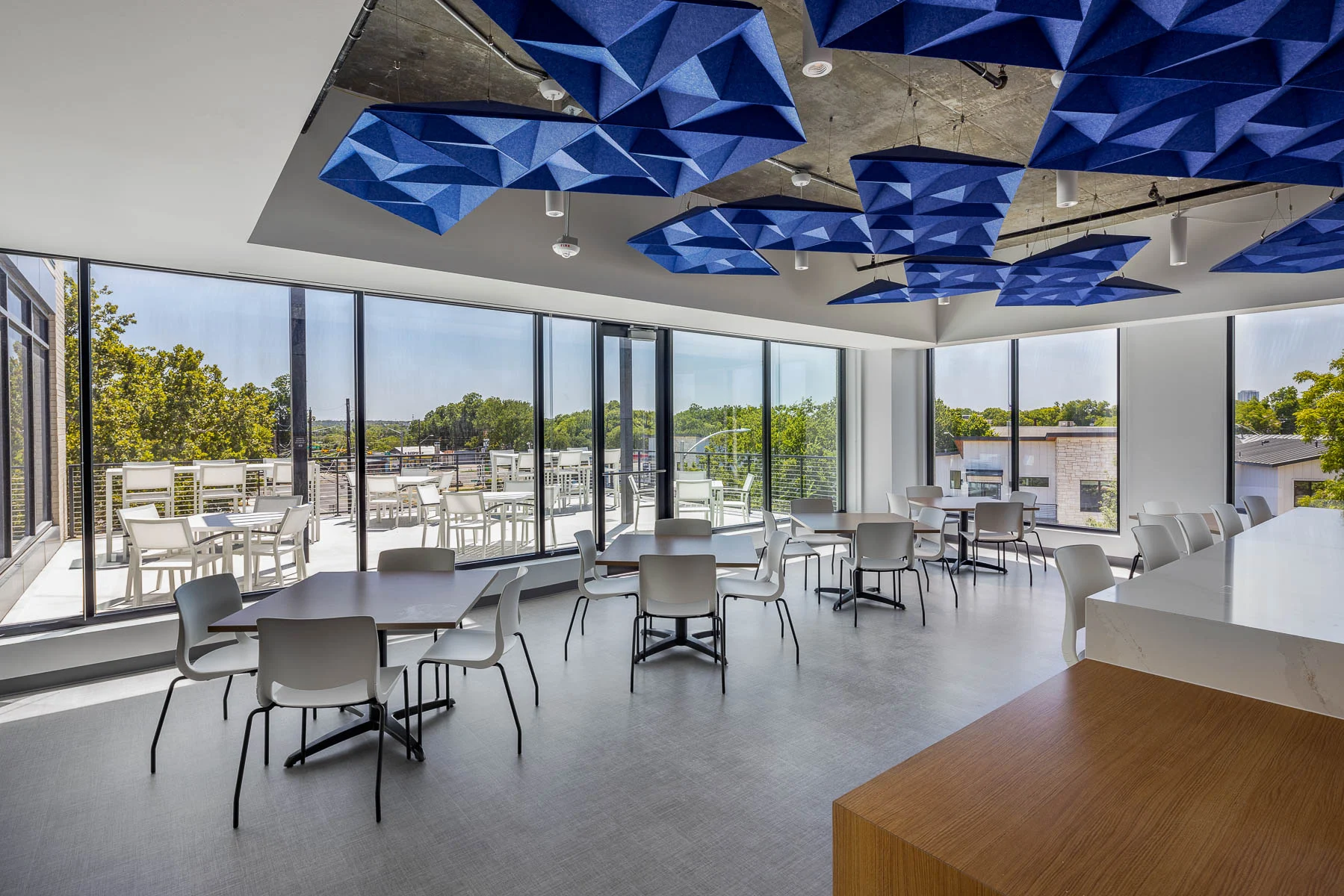 break room with custom blue ceiling artwork and windows