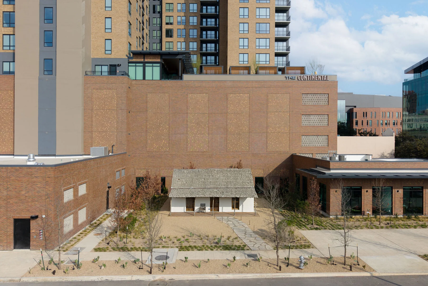 historically preserved home set against high rise mixed use development in downtown san antonio