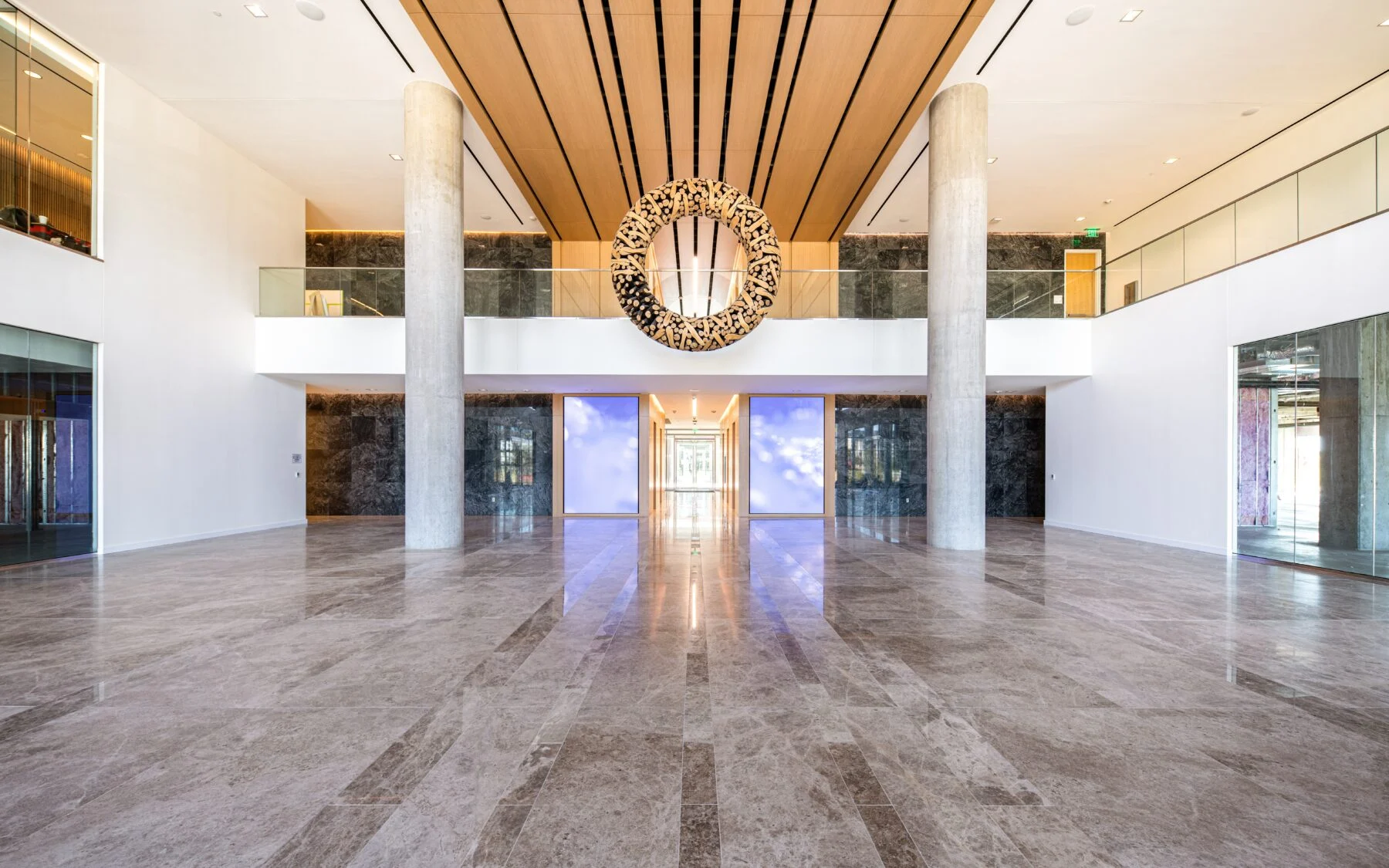 open office space with exposed columns and marble floors