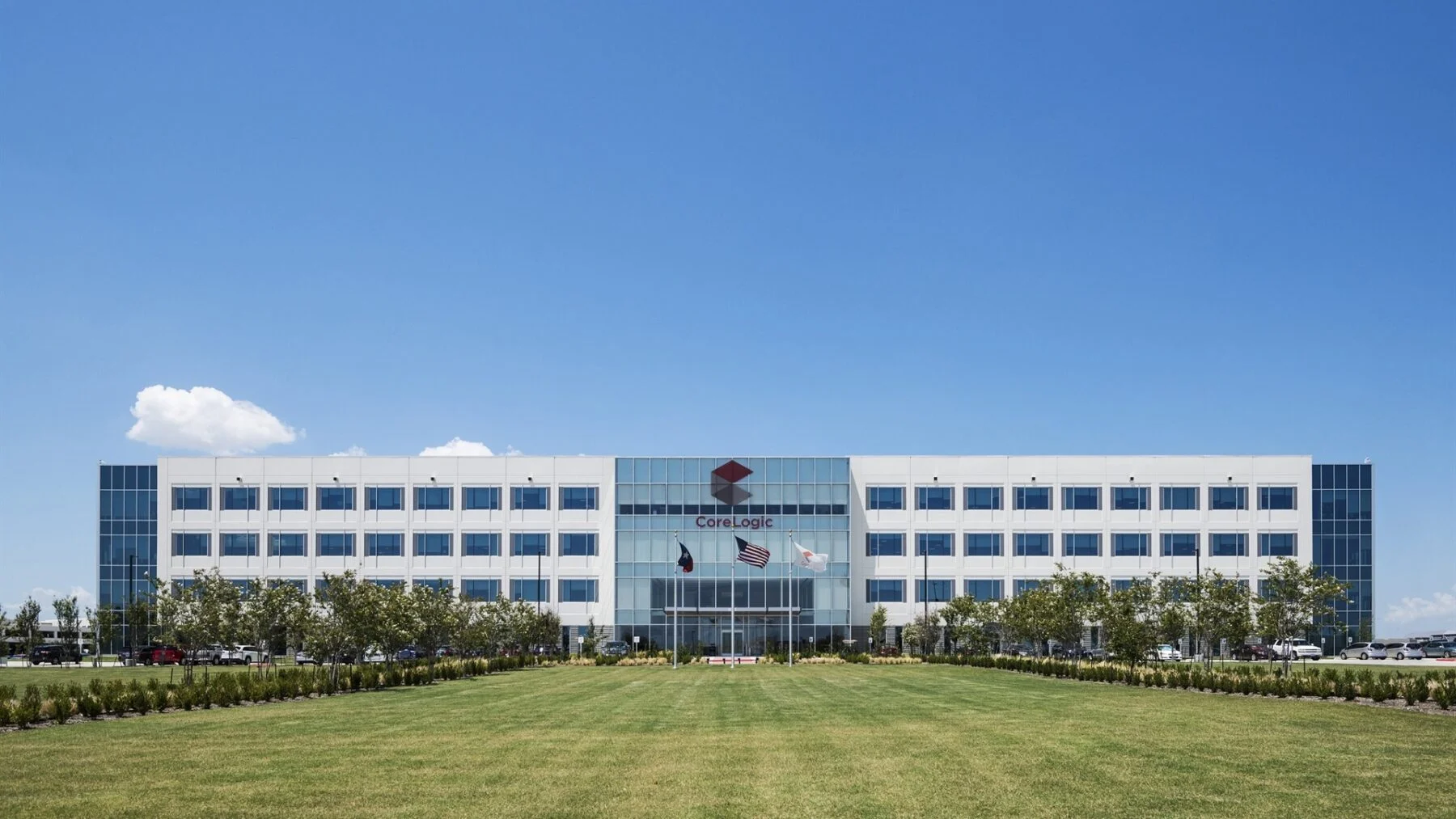four story office building with grass field