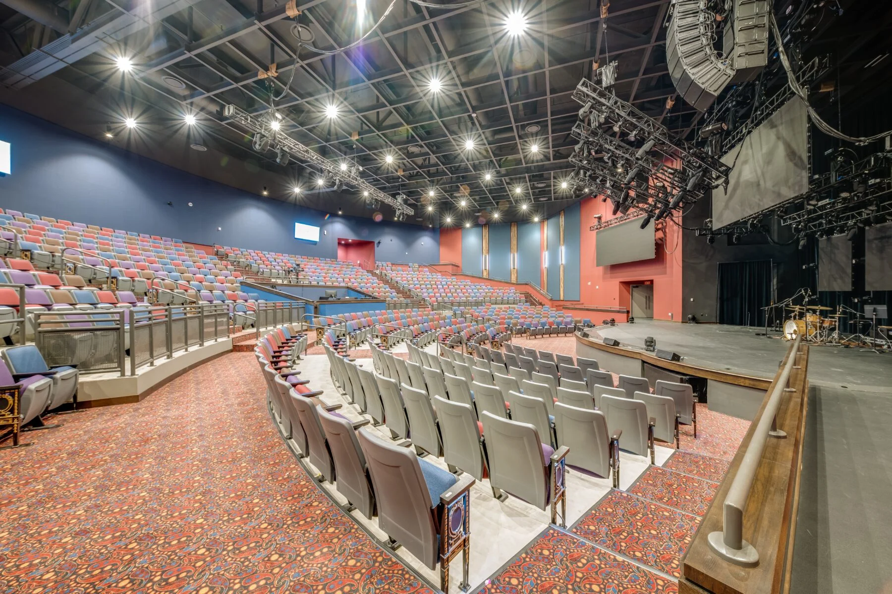 auditorium with seating and stage and speakers
