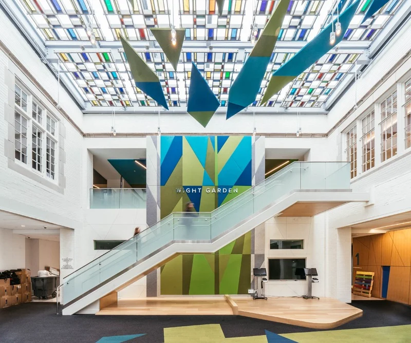two story lobby entrance with custom staircase and ceiling art and full length wall to floor art