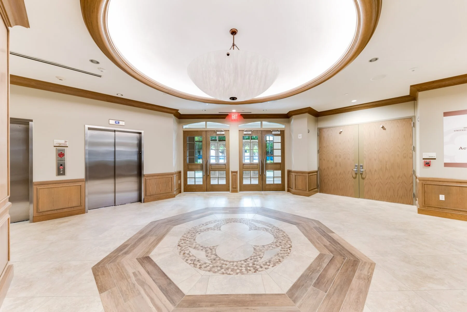 lobby entrance with elevator and custom tile floor