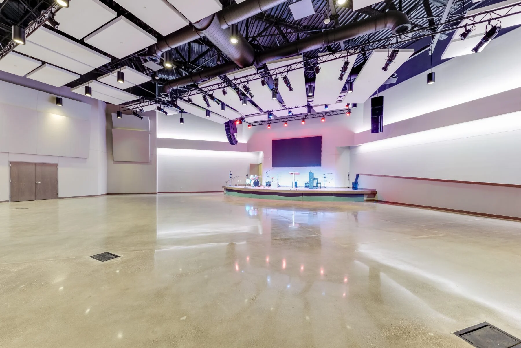 auditorium for gathering with TV screens and speakers