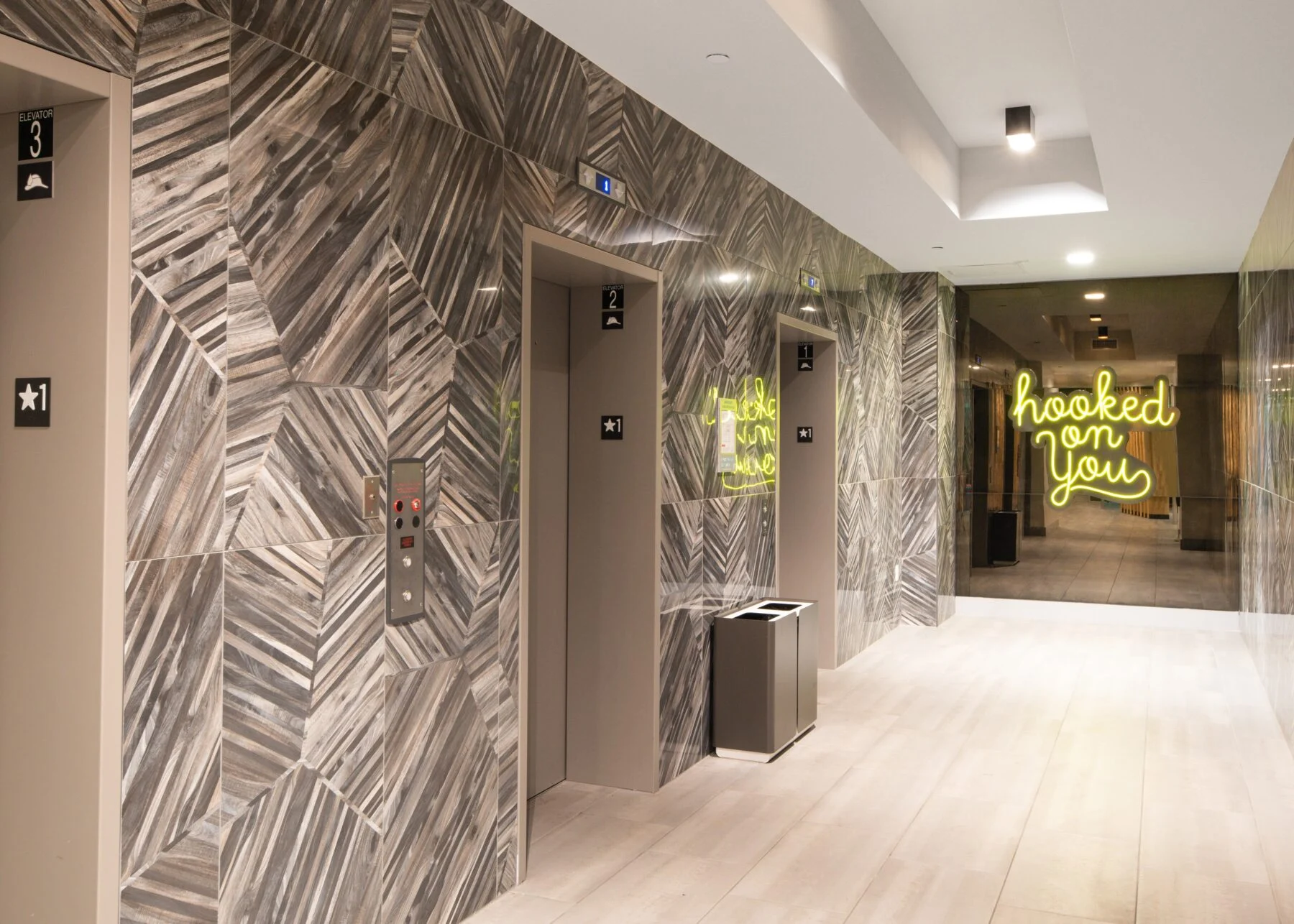 lobby with elevators and unique marble wall