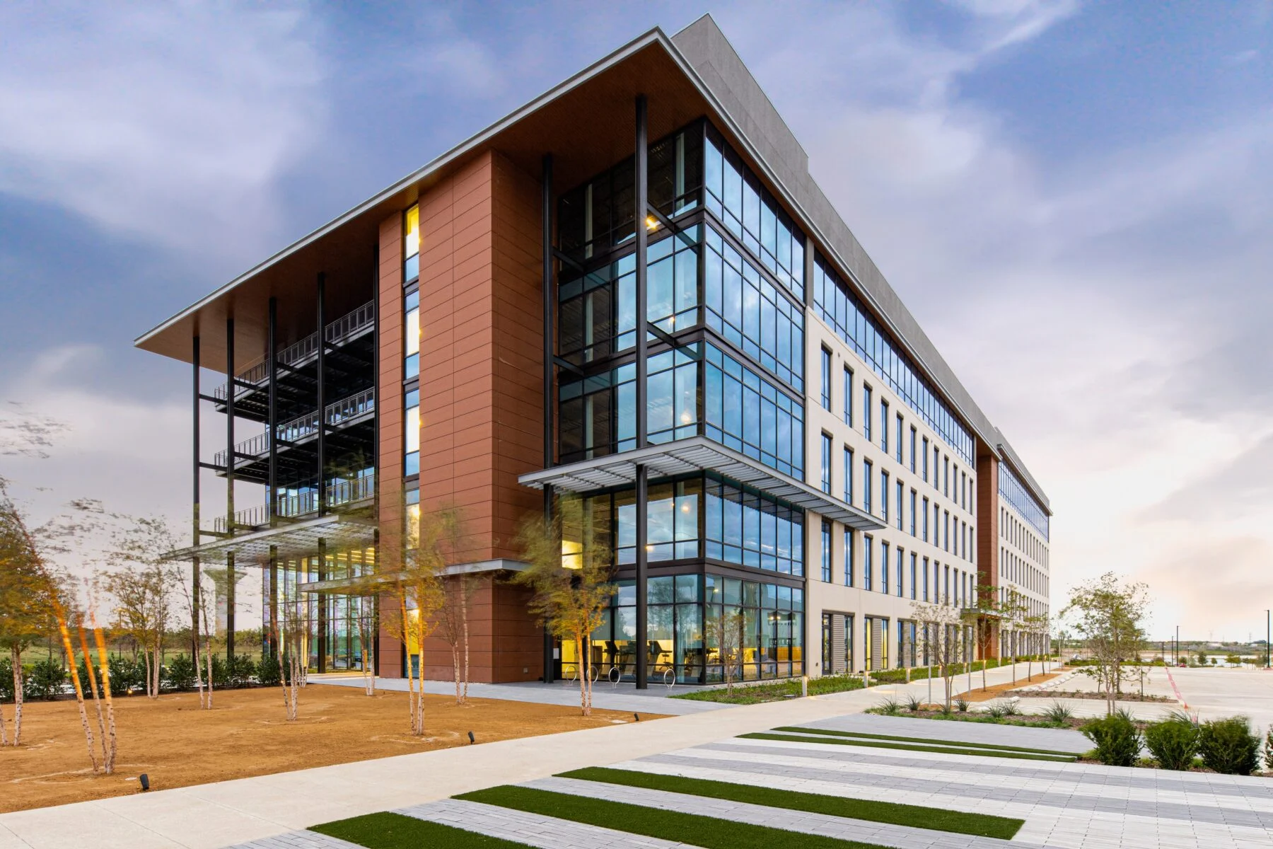 five story office building with floor to ceiling windows
