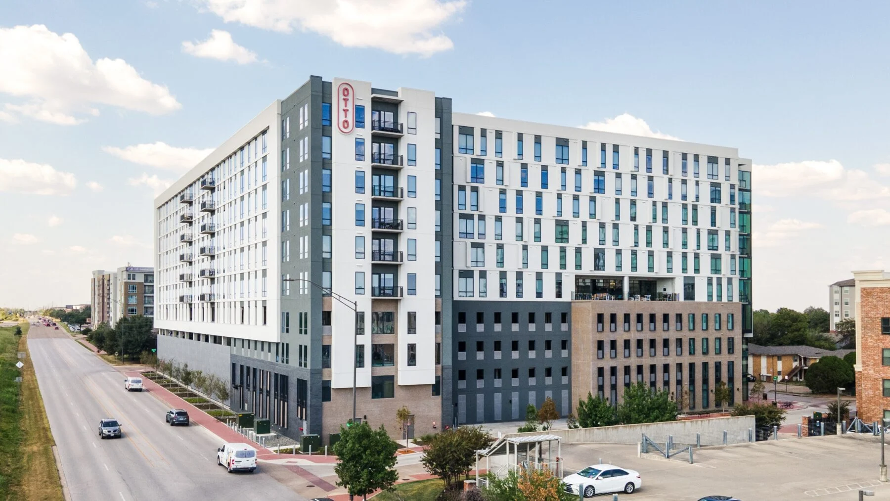 exterior of 10 story apartments with parking garage