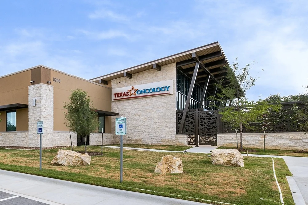 exterior of oncology building features backyard covered patio