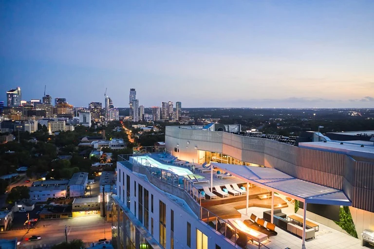 rooftop pool with lounge and skyline view