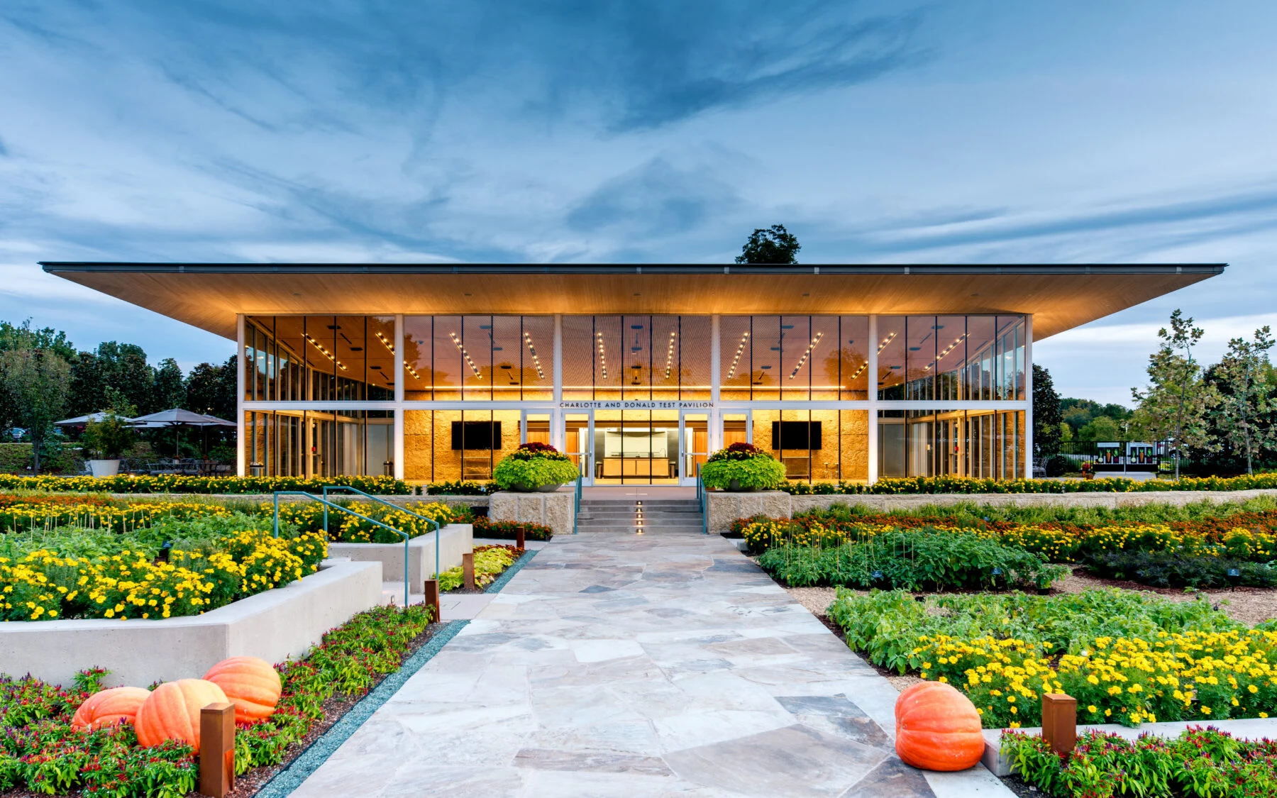 front floor to ceiling glass building with wood awning