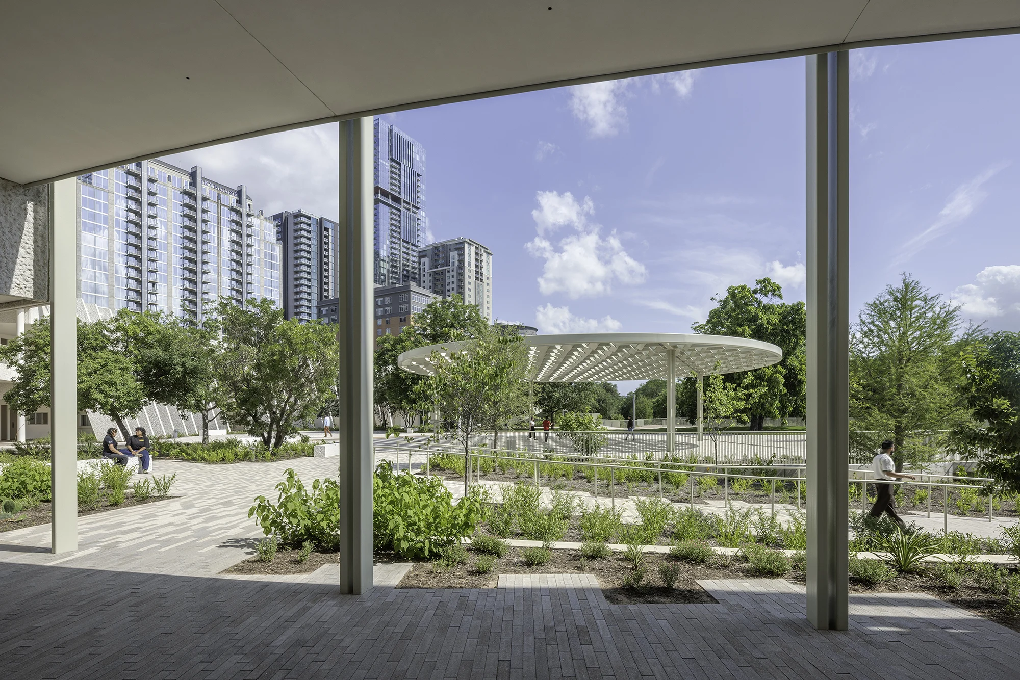 View of the zócalo gathering space from under the canopy of the main MACC building