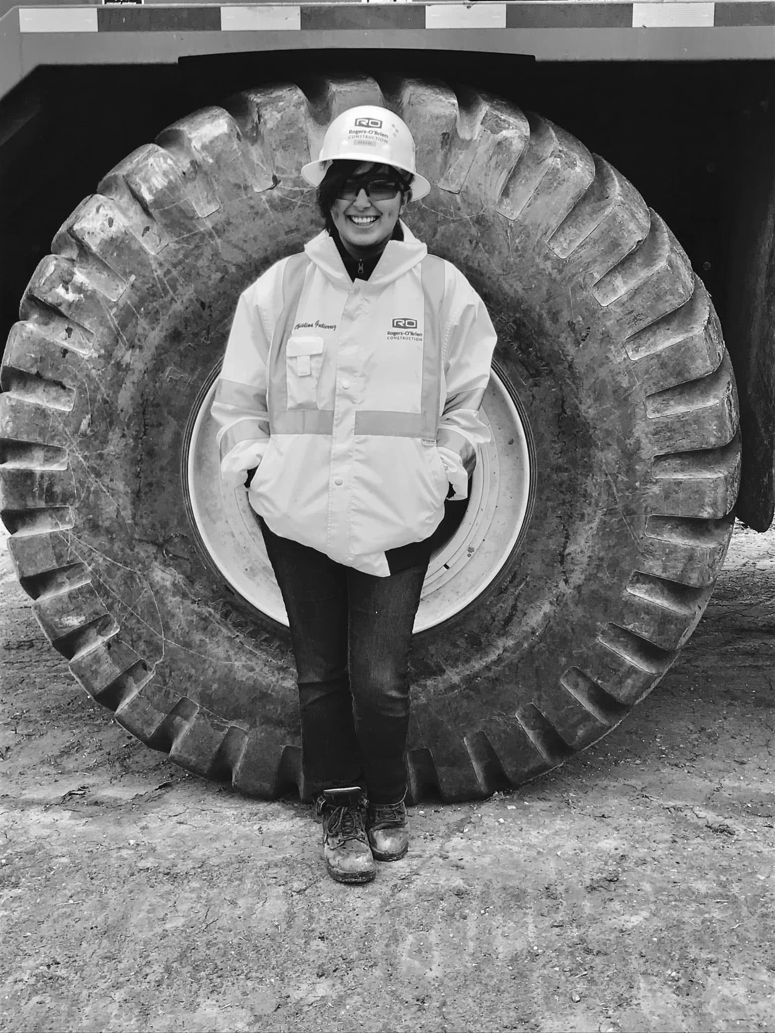 intern on jobsite in front of construction equipment