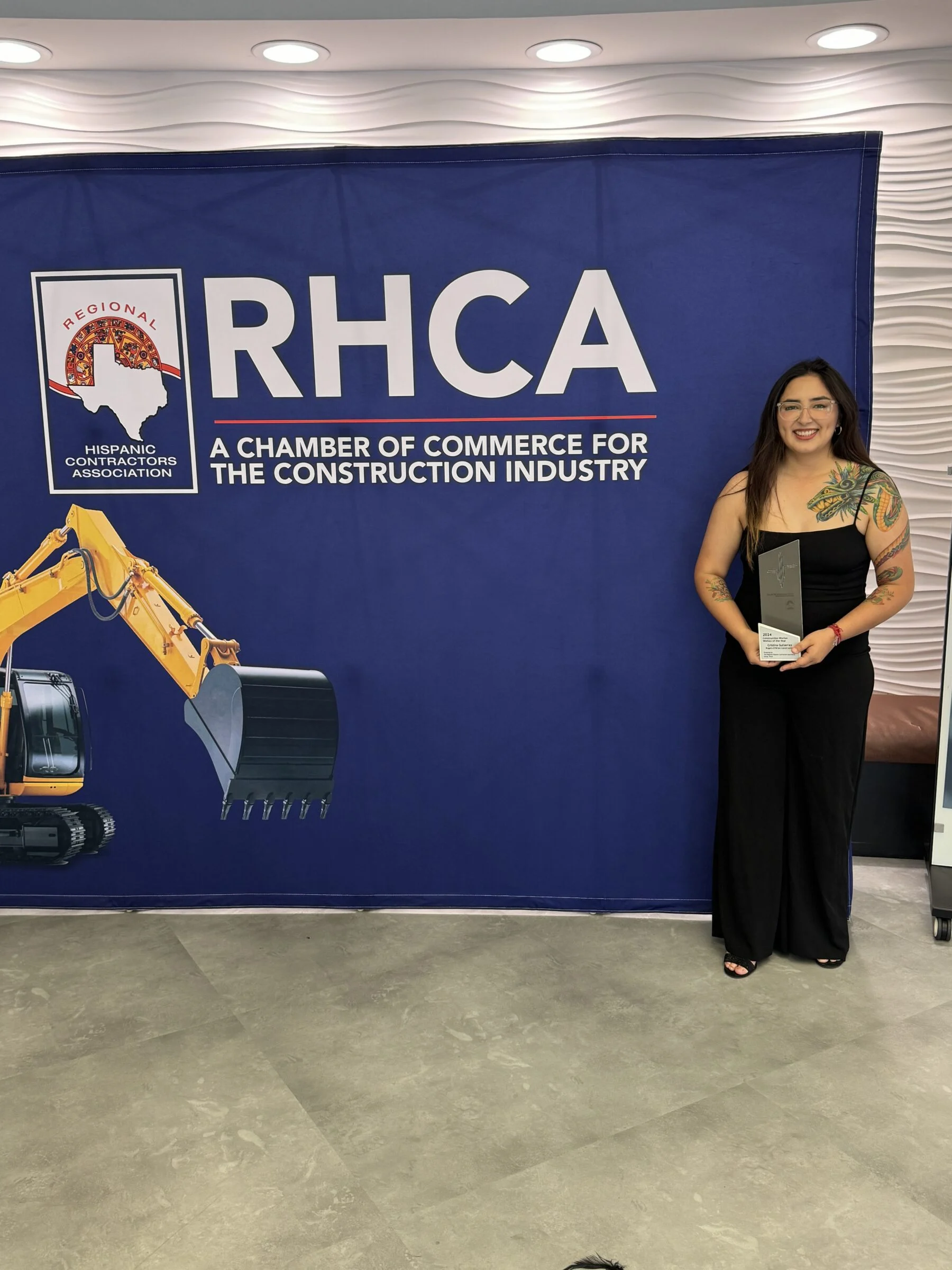 woman accepting construction award