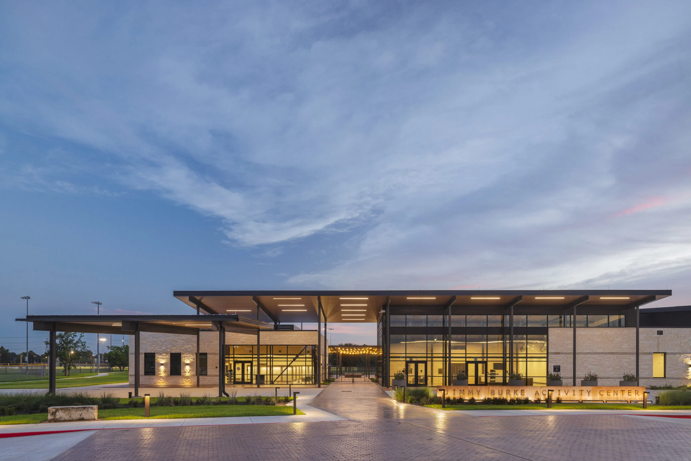 Connecting canopy for the Jimmy Burke Activity Center and Museum at dusk.