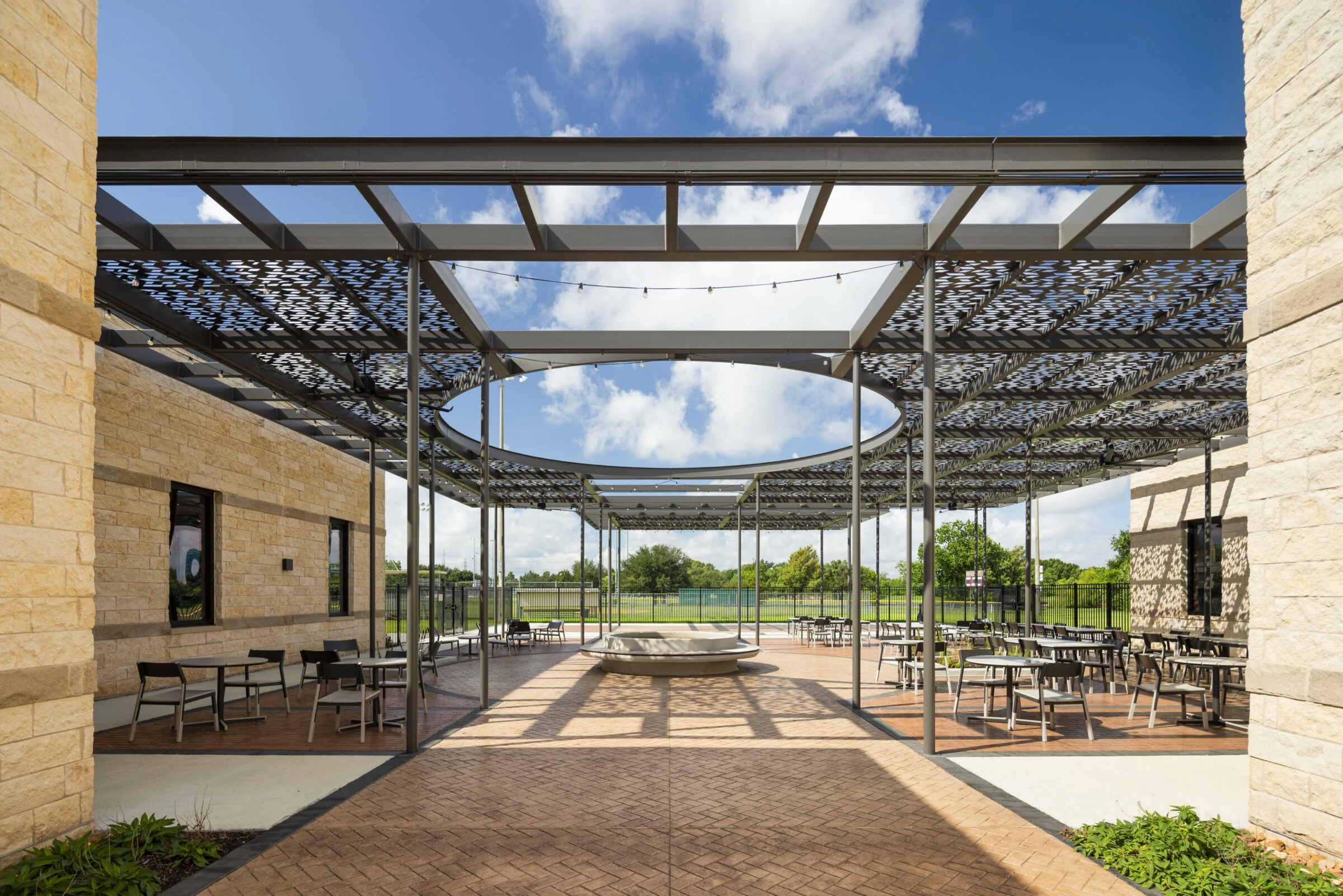 Outdoor canopy with lounging area and fountain at the Jimmy Burke Activity Center.